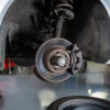 Close-up of car tyre and break disc at repair garage